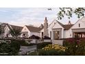 Charming home exterior featuring manicured garden, stone chimney, and traditional design at 6001 N 37Th Pl, Paradise Valley, AZ 85253