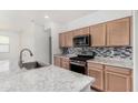 Stylish kitchen with granite countertops, stainless steel appliances, and modern backsplash at 7234 E Eagle Nest Way, San Tan Valley, AZ 85143