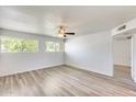 Spacious bedroom featuring a ceiling fan, wood-look flooring, and bright natural light at 920 N 82Nd N St # H203, Scottsdale, AZ 85257