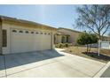 The exterior features a two-car garage, desert landscaping, and a long concrete driveway at 10960 E Monte Ave # 154, Mesa, AZ 85209
