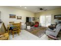 Spacious living room with tile floors, ceiling fan, dining area, and sliding doors to the outside at 10960 E Monte Ave # 154, Mesa, AZ 85209