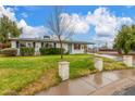 Charming single-story home featuring a well-maintained front yard with privacy landscaping on a partly cloudy day at 14608 N Montego Ct, Phoenix, AZ 85053