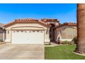 Charming single-story home with well-maintained front yard and attached two-car garage at 15240 W Melissa Ln, Surprise, AZ 85374