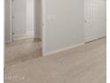 Spacious bedroom featuring neutral carpet and views into tiled hallway with white doors and trim at 17845 W Getty Dr, Goodyear, AZ 85338