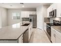 Kitchen with stainless steel appliances, grey backsplash and countertop at 17851 W Getty Dr, Goodyear, AZ 85338