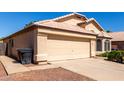 Charming single-story home with a two-car garage, desert landscaping, and a tile roof at 18525 N 85Th N Ave, Peoria, AZ 85382