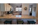 Bright kitchen featuring granite countertops and bar seating, stainless steel appliances at 205 N 74Th St # 104, Mesa, AZ 85207