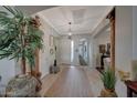 Grand foyer featuring tile floors, arched doorways, and a stylish light fixture at 20766 W White Rock Rd, Buckeye, AZ 85396