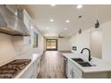 Stylish kitchen with a stainless steel gas range stove and an open floor plan at 2113 N 210Th Ave, Buckeye, AZ 85396