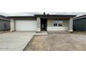 New construction home featuring a two-car garage and covered entry at 22840 E Roundup Way, Queen Creek, AZ 85142