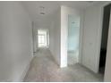 Spacious hallway with neutral paint leading to various rooms at 22840 E Roundup Way, Queen Creek, AZ 85142