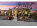 Charming desert home with a two-car garage and a tiled roof and entryway at 26853 W Marco Polo Rd, Buckeye, AZ 85396