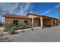 Attractive desert home with a covered porch, mature landscaping, and inviting curb appeal at 30066 N Holly Dr, San Tan Valley, AZ 85144
