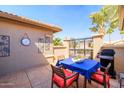 Cozy outdoor patio with dining table, grill, and stylish decor for relaxing or entertaining at 3245 N 147Th Ln, Goodyear, AZ 85395