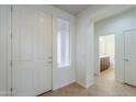 Bright entryway showcasing tile floors, a sidelight window, and a half bathroom at 325 W Seaside Dr, Casa Grande, AZ 85122
