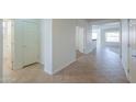 Bright hallway with tile flooring, leading to multiple rooms and featuring neutral paint at 325 W Seaside Dr, Casa Grande, AZ 85122