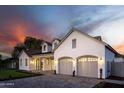 An exterior showcasing a clean garage with arched entryway, paver driveway, and manicured landscaping at 3634 N 47Th St, Phoenix, AZ 85018