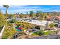 Aerial view of backyard pool with a lounge area, outdoor dining, and lush landscaping at 4114 E Desert Cove Ave, Phoenix, AZ 85028