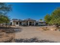 Home's exterior elevation with desert landscaping at 5045 E Calle Del Sol --, Cave Creek, AZ 85331