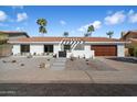 Well-maintained, single-story home with desert landscaping, a red tiled roof, and a two car garage at 7553 E Woodshire Cv, Scottsdale, AZ 85258