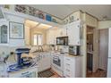 Bright kitchen featuring white cabinets, modern appliances, and a cozy breakfast nook with natural light at 7750 E Broadway Rd # 475, Mesa, AZ 85208
