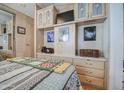 Serene main bedroom with built-in storage, a mounted TV, and a comforting quilt at 7750 E Broadway Rd # 475, Mesa, AZ 85208