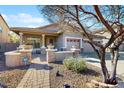 Inviting single-story home featuring a charming front porch and a well-maintained landscape at 8385 W Vogel Ave, Peoria, AZ 85345
