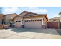 Single-story home featuring a spacious three-car garage and mature landscaping at 8385 W Vogel Ave, Peoria, AZ 85345