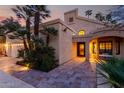 Stunning single-Gathering home exterior highlighting stone walkway, desert landscaping, and covered entrance with bench seating at 8737 E San Vicente Dr, Scottsdale, AZ 85258