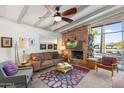 Cozy living room with brick fireplace and a large window that fills the space with natural light at 945 W 10Th St, Mesa, AZ 85201