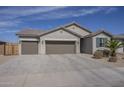 Inviting one-story home boasting a spacious three-car garage, neutral stucco, drought-tolerant landscaping, and a clay tile roof at 1232 E Silver Reef Dr, Casa Grande, AZ 85122