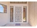 Close-up of the front door with decorative security screen and side windows at 13764 W Meeker Blvd, Sun City West, AZ 85375