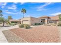 Charming single-story home featuring desert landscaping, tile roof, and an attached two-car garage at 13764 W Meeker Blvd, Sun City West, AZ 85375