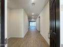 Inviting entryway with light walls, wood-look floors, and recessed lighting at 15781 W Cheryl Dr, Waddell, AZ 85355