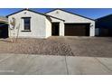 Charming single-story home with a stucco exterior and a well-maintained front yard at 15781 W Cheryl Dr, Waddell, AZ 85355