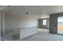 An interior view showcasing a spacious room with drywall and a bar-style element, offering a glimpse of potential design at 15781 W Cheryl Dr, Waddell, AZ 85355