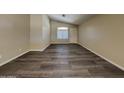 Spacious living room boasts modern dark plank flooring, neutral walls, and natural light at 17914 N Fiano Dr, Maricopa, AZ 85138