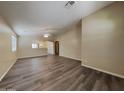 Bright and airy living room with dark plank flooring and open layout at 17914 N Fiano Dr, Maricopa, AZ 85138