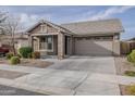 An inviting one-story home features a two-car garage, neutral tones, and tidy landscaping at 22644 E Quintero Ct, Queen Creek, AZ 85142