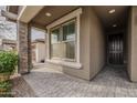 The covered front porch offers a stone pillar and an entryway to the home at 22644 E Quintero Ct, Queen Creek, AZ 85142