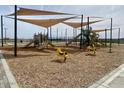 Community playground featuring slides, rocking animals, and ample space for children to play at 22803 E Lords Way, Queen Creek, AZ 85142