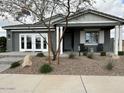 Charming single story home featuring a covered porch and low maintenance desert landscaping at 22808 E Roundup Way, Queen Creek, AZ 85142