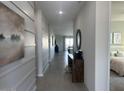 Hallway with modern wall accents leading to a bedroom and living area with natural light at 22808 E Roundup Way, Queen Creek, AZ 85142