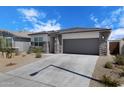 Inviting single-story residence with stone detailing, low-maintenance landscaping, and a two-car garage at 24220 W Ripple Rd, Buckeye, AZ 85326