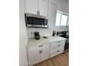 Close up of modern kitchen area featuring stainless steel microwave and appliances at 2440 W Morten Ave, Phoenix, AZ 85021