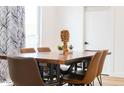 Dining room features a wooden table, leather chairs, and a modern light fixture at 2441 W Morten Ave, Phoenix, AZ 85021