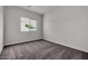 Cozy bedroom featuring plush carpet, neutral walls, and a bright window, creating a comfortable and inviting space at 2524 N Pony Ln, Casa Grande, AZ 85122