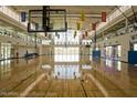 Bright and spacious gymnasium featuring hardwood floors, high ceilings, and ample natural light at 2649 N Riverside Dr, Florence, AZ 85132