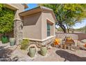 Private courtyard featuring stone accents, an outdoor seating area, and lush landscaping at 27582 N 67Th Way, Scottsdale, AZ 85266