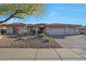 Charming single-story home with a well-manicured desert landscape and a spacious three-car garage at 3109 W Summit Walk Ct, Anthem, AZ 85086